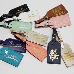 the luggage tags are all different colors and styles, but each has a name tag attached to them