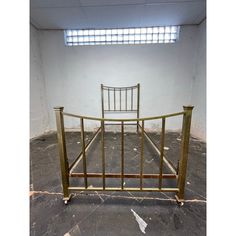 a metal bed frame in an empty room