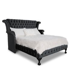 a black bed with white sheets and pillows on it's headboard, in front of a white background