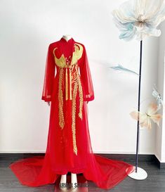 Handmade red bridal Ao Dai with finest Phoenix embroidery by yours truly.  Color :  Red and gold embroidery  Details:  Traditional Vietnamese Ao Dai jacket  Flares Long sleeves  Front closing with button  Cathedral length  Shop other AO DAI: https://etsy.me/3E9ppC7 Turnaround time: Due to the delicate nature of the handcrafted goods we produce this beautiful dress has creation time of approximately 6-10 weeks  Estimated shipping times : ✅Standard shipping: 3-6 weeks for most countries  ✅Expedite Red Floor-length Gown For Traditional Ceremonies, Traditional Red Long Sleeve Gown, Traditional Long Sleeve Red Gown, Traditional Red Gown With Long Sleeves, Red Long Sleeve Gown For Festivals, Traditional Red Ao Dai For Ceremony, Traditional Red Long Gown, Traditional Long Red Gown, Ceremonial Red Dress With Traditional Drape