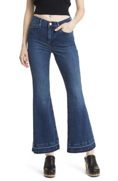 Released raw hems relax the style of casual-chic flare jeans made from soft, lightweight stretch denim in a polished dark-indigo wash. 31" inseam; 22" leg opening; 11" front rise; 15" back rise (size 29) Zip fly with button closure Five-pocket style 77% cotton, 18% modal, 4% elasterell-p, 1% elastane Machine wash, dry flat Made in Turkey Denim Flare Jeans For Workwear, Flare Denim Jeans For Work, Spring Dark Wash Flare Jeans With Flared Hem, Spring Dark Wash Flares With Five Pockets, Dark Wash Mid-rise Flares For Spring, Luxury Relaxed Fit Flare Jeans With Frayed Hem, Chic Dark Wash Flares With Frayed Hem, Spring Dark Wash Flared Hem Flare Jeans, Mid-rise Dark Wash Flares With Frayed Hem