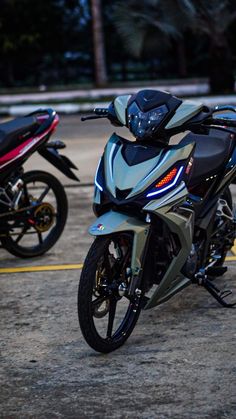 two motorcycles parked next to each other in a parking lot