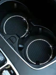 two speakers in the center console of a car with diamond trimmings on them