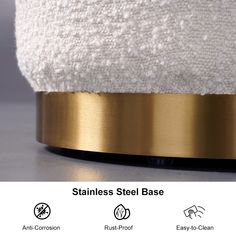 an image of a white and gold lamp on top of a table with text stating stainless steel base