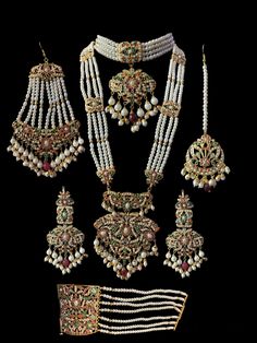 bridal set includes choker , earrings , jhoomar , tika , ring , bracelet and Rani haar made using cz stones , shell pearls , beads and gold plating Kundan Bridal Sets With Stone Work For Marriage, Traditional Pearl Jewelry For Marriage, Pearl Chandbali Sets With Stone Work, Bollywood Style Pearl Sets With Stone Work, Kundan Sets With Stone Work For Wedding, White Sets With Stone Work For Marriage, Rani Haar, Silver Jewelry Earrings, Silver Jewelry Pendant