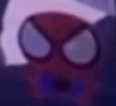 a blurry image of a red and white spider man with big eyes on it's face