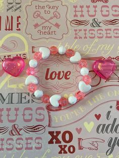 two pink and white bracelets with hearts on them