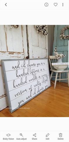 a wooden sign sitting on top of a hard wood floor next to a white chair