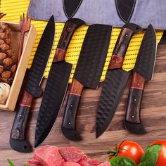 five knives are lined up on a cutting board next to fresh vegetables and pineapples