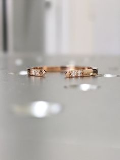 two wedding rings sitting on top of a counter