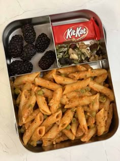 a metal container filled with pasta and blackberries