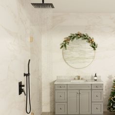 a bathroom with a sink, shower head and christmas wreath on the wall above it