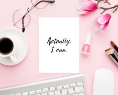 a pink desk with flowers, eyeglasses and a note that says grace & hustle