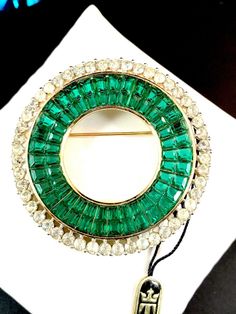 NWT CROWN TRIFARI PHILIPPE INVISIBLY SET EMERALD GREEN RHINESTONE CIRCLE BROOCH | eBay Green Round Brooch For Formal Occasions, Green Round Brooch Jewelry, Green Round Brooch, Formal Round Gemstone Brooches, Green Round Brooches For Wedding, Green Round Wedding Brooches, Trifari Brooch, Trifari Jewelry, Bubble Necklaces