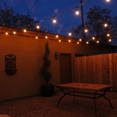 an outdoor patio with lights strung over it