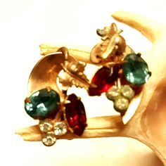 Vintage Prong Set Crystal Cluster Gold Tone Screw Back Earrings perfect for women who love retro granny core style. Crafted from metal, these earrings are 1 3/8" x 6/8" in size, featuring red, blue, and clear crystals. * Brand: Unknown * Color: Red/Blue/Clear * Size: 1 3/8" x 6/8" * Style: Crystal Cluster * For: Women * Material: Metal Features: * Crystal Cluster Size: Womens 1 3/8" x 6/8" Condition: Pre-Owned Good Lovely Vintage Condition Vintage Jewelry For Christmas Anniversary, Retro Jewelry With Matching Earrings For Vintage Collection, Retro Earrings With Vintage Charm For Gift, Retro Clip-on Jewelry For Gifts, Retro Clip-on Earrings For Gift, Vintage Metal Clip-on Earrings For Gift, Vintage Multicolor Clip-on Earrings For Party, Luxury Vintage Red Clip-on Earrings, Vintage Clip-on Earrings With Sparkling Stones For Party