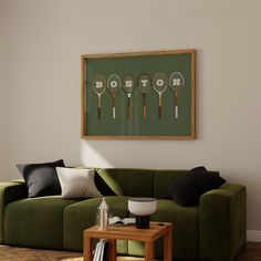 a living room with a green couch and four tennis racquets mounted on the wall