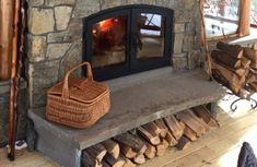 an outdoor fireplace with logs and a basket