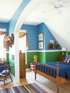 a bedroom with blue and green walls, striped rugs, wooden furniture and an arched ceiling