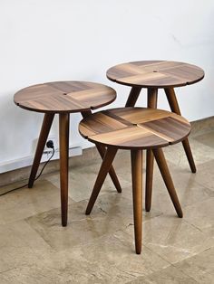 three wooden tables sitting next to each other