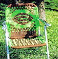 a green lawn chair sitting in the grass