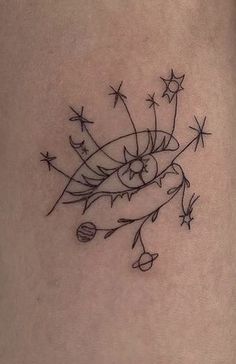 a woman's thigh with stars and an arrow tattoo on the side of her leg