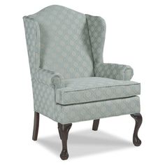 an upholstered wing chair with blue fabric