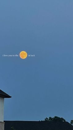 the full moon is seen in the sky above a building with a clock on it