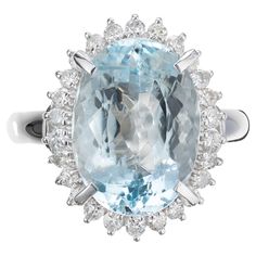 an oval blue topazte and diamond ring with two rows of diamonds surrounding it