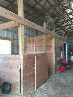 the inside of a barn with wooden walls and flooring, including a chicken coop