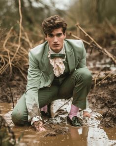 Photo of a handsome young man crawling through thick mud in a pastel green tuxedo jacket and ruffled white shirt The post Young Man Crawling Through Mud appeared first on The Candie | Inspirational Digital Art by The Candie. Pastel Green Tuxedo, Man Crawling, Black Patent Leather Loafers, Green Tuxedo, Green Bow Tie, Green Trousers, Patent Leather Loafers, Green Bows