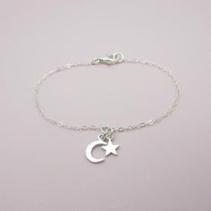 ALL SOLID STERLING SILVER PARTS - A QUALITY BRACELETThis high quality bracelet is made using adorable sterling silver charms in a moon and star shape.  A sturdy sterling silver chain and lobster clasp make this a durable bracelet. Comes in a gift box perfect for gift giving. Moon charm measures approximately 3/8 inch tall and the star 1/4 inch tall. SIZING - IMPORTANT: To determine bracelet size, measure snugly around your wrist and add 1/2 inch to get your bracelet size. Do NOT order in your ex Celestial Charm Bracelet With Moon Charm As A Gift, Dainty Sterling Silver Bracelet With Star Charm, Adjustable Sterling Silver Star Bracelet, Silver Celestial Bracelets For Gift, Celestial Sterling Silver Bracelets, Silver Moon-shaped Bracelet For Gifts, Celestial Charm Bracelet With Star Charm As Gift, Adjustable Silver Celestial Charm Bracelet, Celestial Star Charm Bracelet Gift