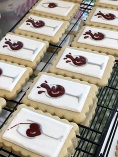 some cookies with icing on them sitting on a cooling rack