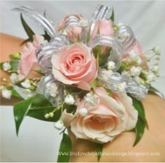 a close up of a person's hand holding a bouquet of flowers