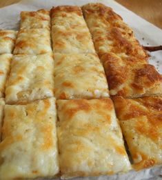 several slices of cheese pizza sitting on top of a white paper towel next to each other