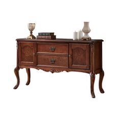 a wooden sideboard with drawers and candles on top