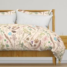 an image of a bed with floral comforter and pillows on the headboard area