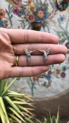 Bring a little desert magic to your next jewelry piece with this sterling silver hummingbird. It was carved on the front and back side so you can see the a mirrored image if you flip it over. This piece can be used as a charm by soldering a jump ring on it, or sweat solder to your base while soldering your next cabochon ring or pendant! Approximately 16x20 mm. Price per each. SPECIFICATIONS: Weight: 1.39 g (0.049 ounces) Overall length/dimensions: 16 x 20 mm Thickness: 2 mm Metal type: Sterling Unique Silver Jewelry With Bird Design, Adjustable Silver Jewelry With Bird Design, Desert Magic, Cabochon Ring, Mirror Image, Soldering, Jump Rings, Jewelry Supplies, Types Of Metal