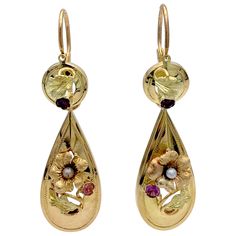 These earrings are called day and night earrings because the tops can be worn by them selves. The earrings have been executed in three different gold hues and embellished with fine engraving.