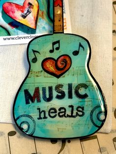 a blue guitar with music heals on it's neck and musical notes in the back