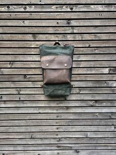 "This daypack is especially designed for the days you want to travel light. Large enough to take all your necessities, not to bulky to take it everywhere with you. Made from Heavy weight waxed canvas in the colour forest green, with outside pocket in waxed leather The pack closes with a zipper on top, the outside pocket with a flap and pouch button. With detachable and adjustable vegetable tanned leather shoulder straps, and carry on handle. The bag measures wide 28 cm on top / 19 cm at the bott Leather Backpack With Waxed Finish For Outdoor, Leather Backpack With Waxed Finish For Outdoor Activities, Waxed Canvas Leather Backpack For Outdoor, Outdoor Waxed Canvas Backpack With Leather Patch, Outdoor Leather Backpack With Zipper Pocket, Waxed Canvas Leather Backpack For Outdoor Activities, Leather Backpack With Zipper Pocket For Outdoor, Outdoor Leather Patch Backpack, Daily Use Waxed Canvas Backpack With Waxed Finish