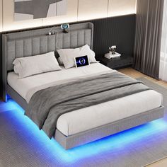 a bed that has some lights on the headboard and foot board in front of it