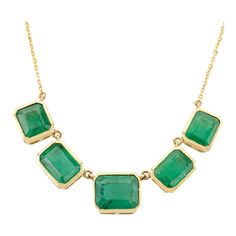 This elegant 18K yellow gold necklace features a modern bezel-set emerald, showcasing its vibrant green hue. The minimalist design highlights the gemstone's natural beauty, making it perfect for everyday wear or special occasions. With its timeless appeal and luxurious finish, this necklace adds a sophisticated touch to any ensemble. Accessorize your look with this elegant emerald Chain Pendant necklace. This stunning piece of jewelry instantly elevates a casual look or dressy outfit. Comfortable and easy to wear, it is just as exquisite worn alone or layered with other charms for a modern fashion statement.  PRODUCT DETAILS :-  Material - 18K Yellow Gold Gemstone - Emerald  Gemstone Weight - 9.25 ct Gemstone pieces - 5  Gemstone size - 7.3 X 8.8, 6.6 X 6, 5.7 X 7.3 mm Gemstone shape - Eme Yellow Gold Necklace With Emerald Cut Bezel Setting, Yellow Gold Emerald-cut Necklace With Bezel Setting, Yellow Gold Emerald Cut Necklace With Bezel Setting, Formal Green Emerald Gemstone Necklace, Classic Green Emerald Necklace With Bezel Setting, Formal Emerald Necklace With Bezel Setting, Fine Emerald Necklaces With Bezel Setting, Luxury Emerald Necklace With Bezel Setting, Modern Green Necklace For Formal Occasions