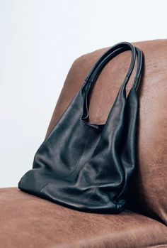 Black Leather Bucket Bag With Smooth Grain, Black Smooth Grain Bucket Shoulder Bag, Chic Black Smooth Grain Hobo Bag, Black Smooth Grain Tote Bag, Chic Black Shoulder Bag With Smooth Grain, Chic Black Hobo Bag With Smooth Grain, Black Smooth Grain Hobo Bag For Daily Use, Black Leather Hobo Bag With Smooth Grain, Modern Black Hobo Bag With Smooth Grain