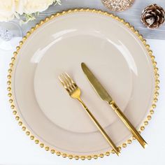 a white plate topped with two golden forks