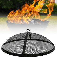 a fire pit sitting on top of a grass covered field