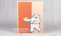 a card with a bear holding a heart on it's back and the words, love is in the air