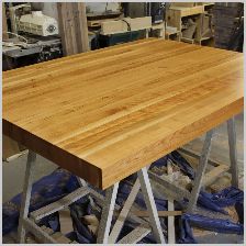 a wooden table with metal legs in a shop