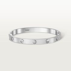 Cartier - LOVE Bracelet, Brushed Finish - Bracelet White gold/Gold - LOVE bracelet, white gold 750/1000, brushed finish. Comes with a screwdriver. Width: 6.1 mm. Created in New York in 1969, the LOVE bracelet is a jewelry design icon: a close fitting, oval bracelet composed of two rigid arcs, which is worn on the wrist and removed using a special screwdriver. The closure is designed with two functional screws placed on either side of the bracelet: you will need help to open or close it. To deter Oval Bracelet, Bracelet White Gold, Lovers Bracelet, Bracelet Love, Love Bracelet, Design Icon, Cartier Love, Jewelry Lookbook, Timeless Jewelry