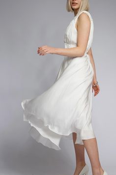 White Dress in Roman Style with Ties Immerse yourself in an atmosphere of refined elegance with this stunning white dress in Roman style. Crafted from lightweight, flowing fabric, it perfectly contours the figure, creating an airy and romantic silhouette. The ties accentuating the waist add a touch of modernity and originality. The fabric drapes beautifully, cascading along the silhouette to provide layers and volume. The midi length makes this dress a versatile choice -- it is perfect for both evening outings and daytime strolls, complementing various heel heights. The pure white color symbolizes freshness and impeccable style, while the loose fit ensures comfort year-round. Pair it with delicate accessories and footwear for a complete look. This dress is your key to impeccable style and Roman Style Dresses, Romantic Silhouette, Roman Style, Flowing Fabric, Roman Fashion, Dress With Tie, Draped Fabric, Dress Clothes For Women, Midi Length